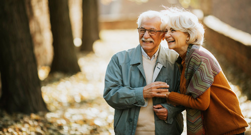 senior-couple-walking-in-autumn-park